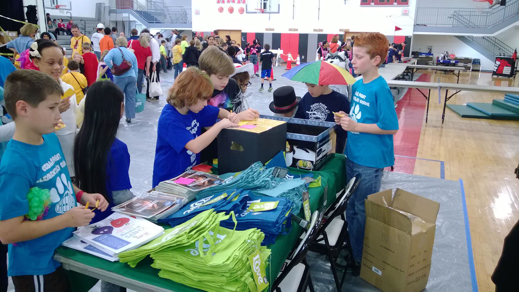 Students selling blue t-shirts.