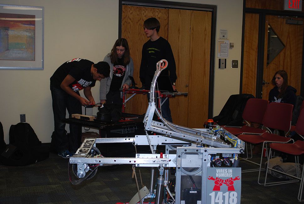 The robot with team members in the background.