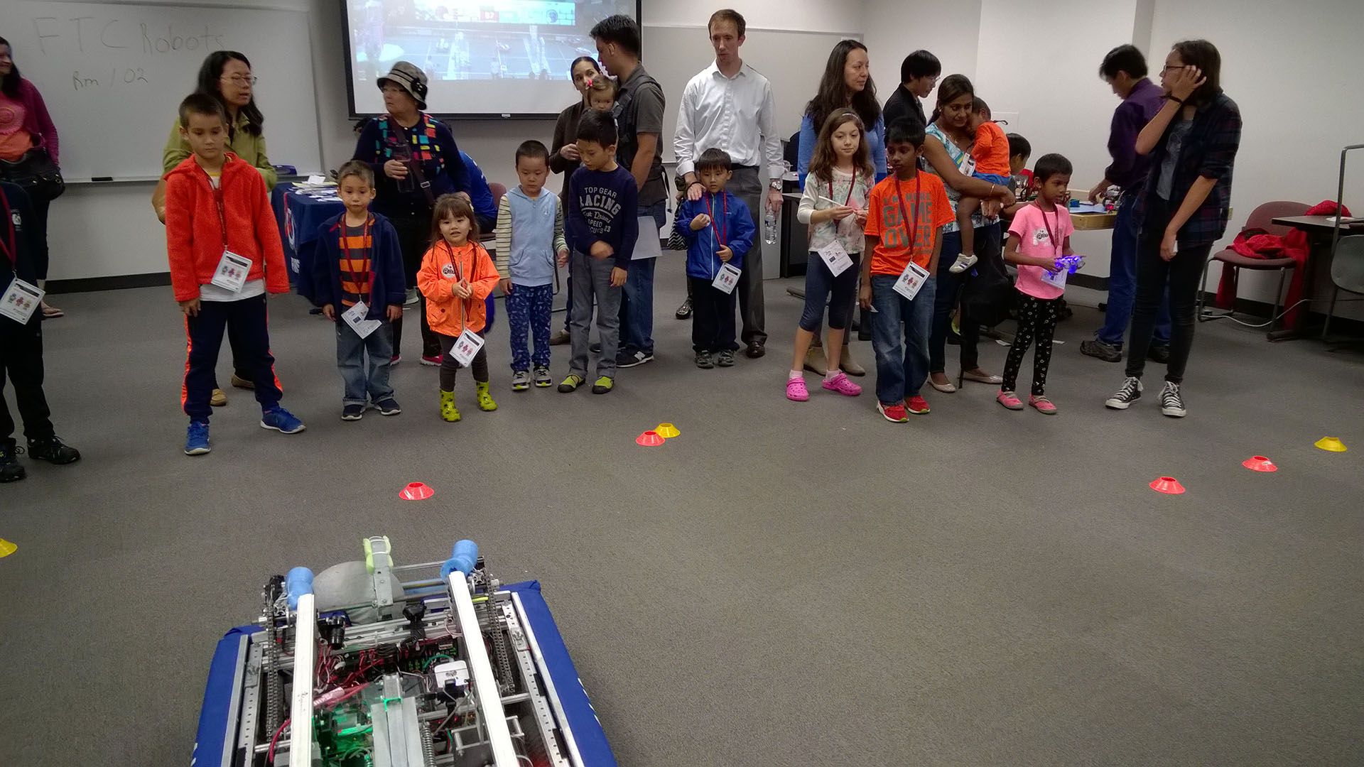Children and parents watching the robot.