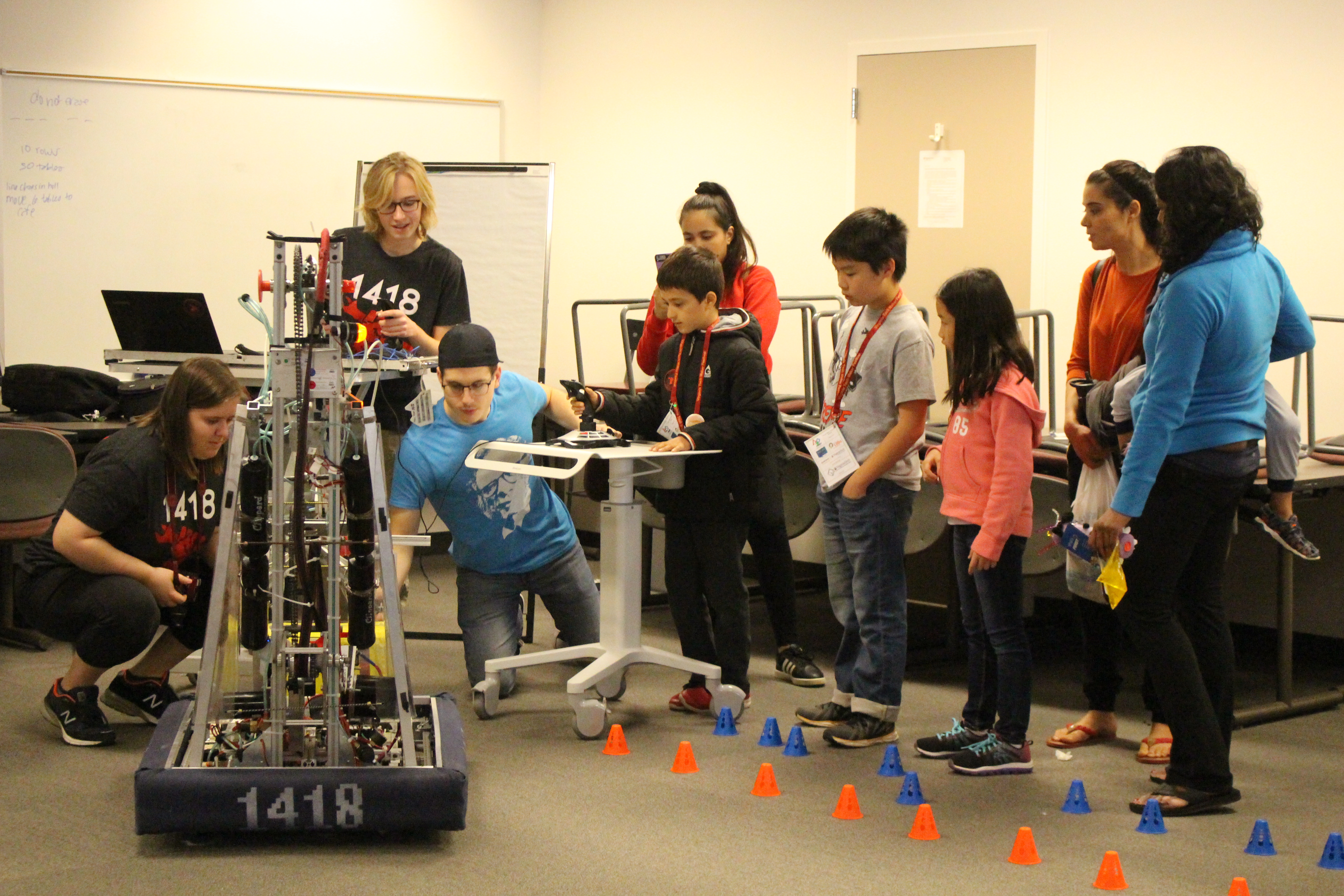Children line up to drive the robot.