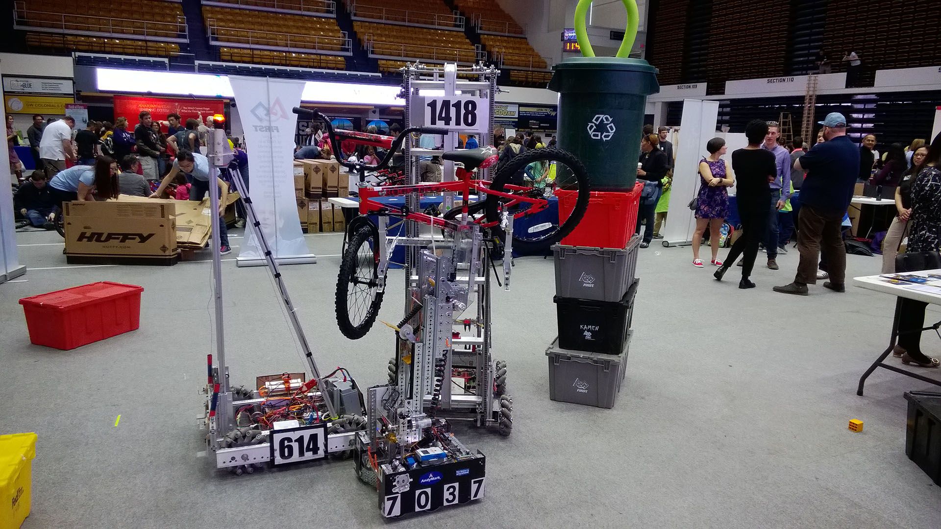 The 2015 robot holding up a red bike.
