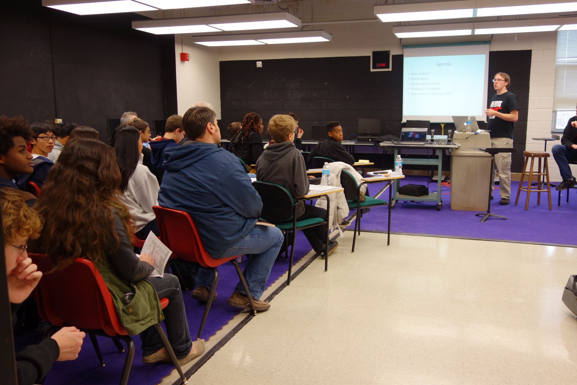 Students attending a 2015 workshop in a purple-and-black room.
