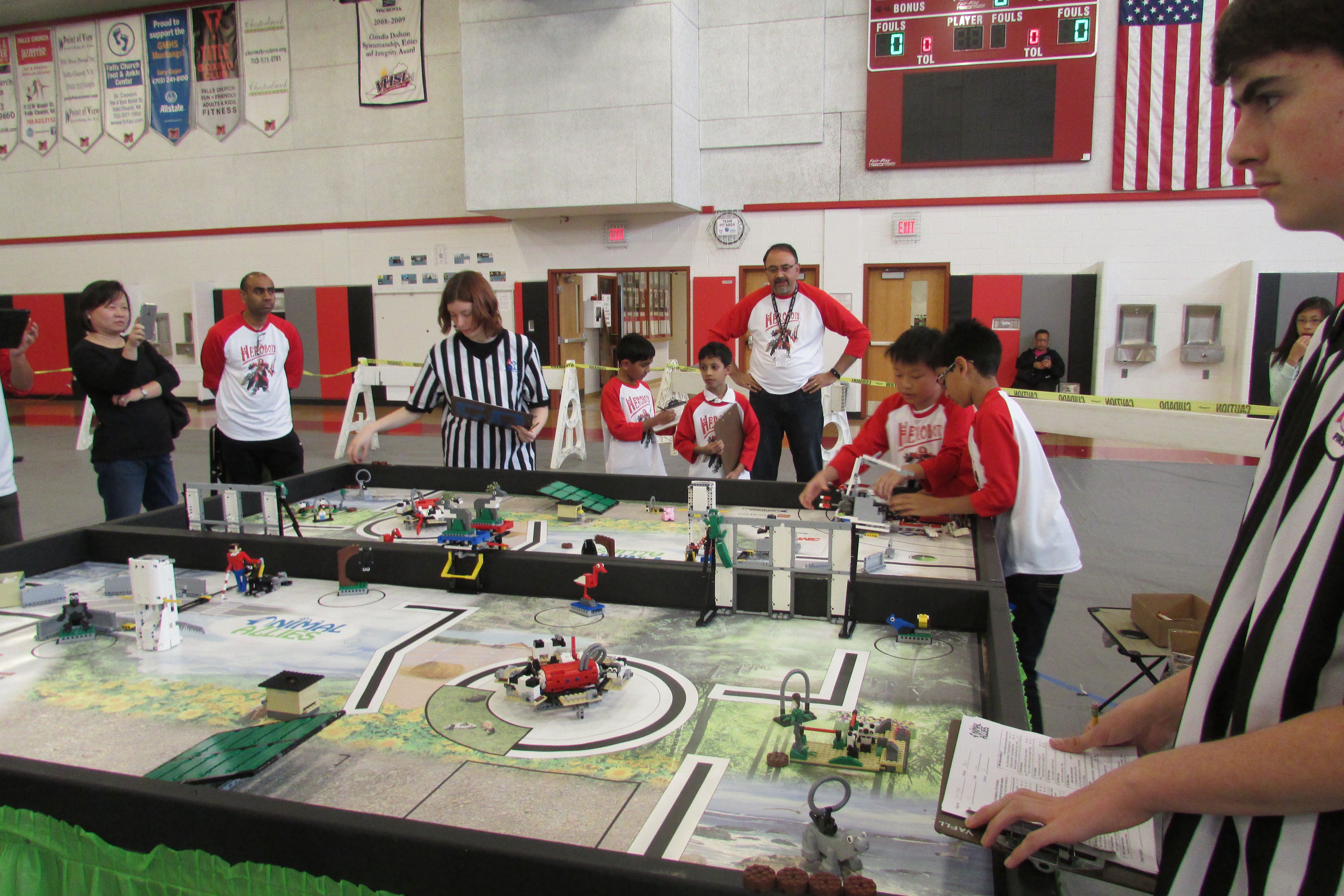 A referee standing in front of a miniature pit.