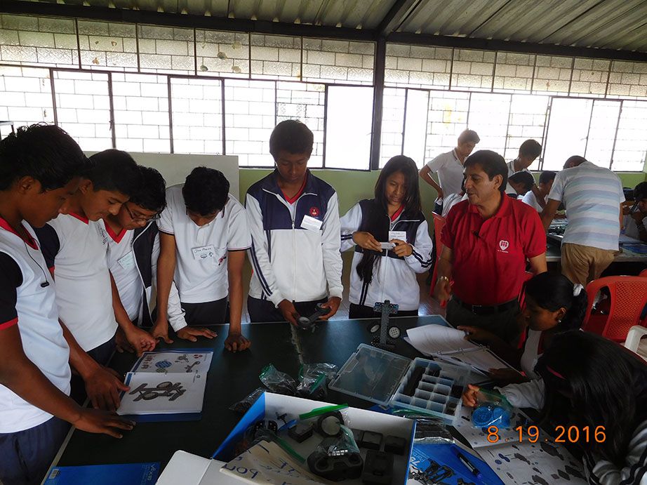 San Miguel de los Bancos students reading directions to build a robot.