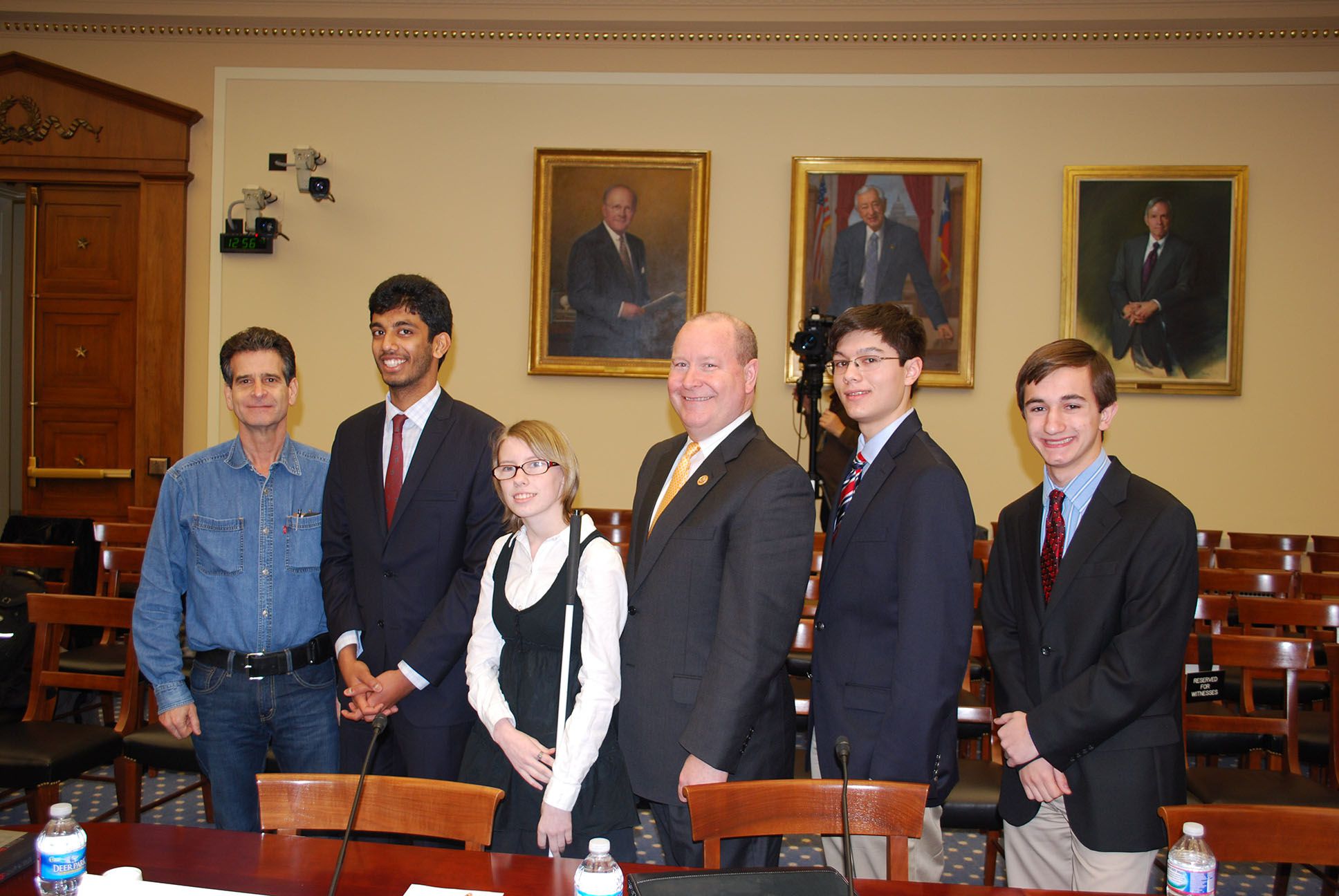 Team members standing up for a photo in court.